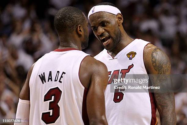 Dwyane Wade and LeBron James of the Miami Heat react in the fourth quarter while taking on the Dallas Mavericks in Game Two of the 2011 NBA Finals at...