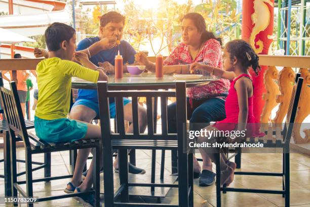 indian family with restaurant - indian restaurant stock pictures, royalty-free photos & images
