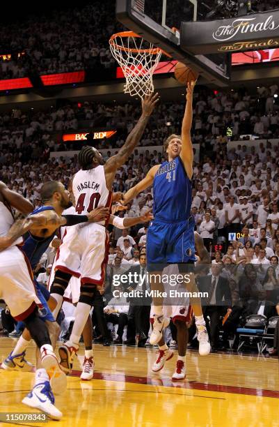 Dirk Nowitzki of the Dallas Mavericks makes the game-winning shot to put the Mavericks up 95-93 with 3.6 seconds left in the game against Udonis...