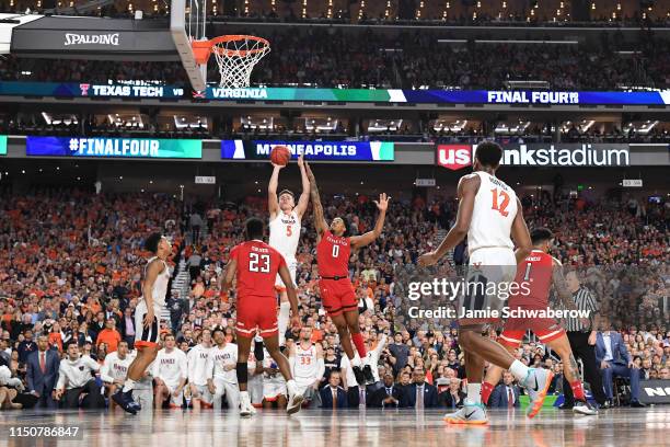 Kyle Guy of the Virginia Cavaliers shoots over Kyler Edwards of the Texas Tech Red Raiders during the 2019 NCAA Photos via Getty Images Men's Final...