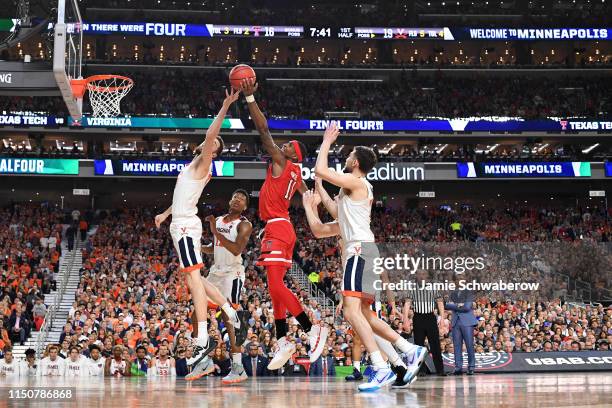 Jay Huff of the Virginia Cavaliers and Tariq Owens of the Texas Tech Red Raiders battle for a rebound during the 2019 NCAA Photos via Getty Images...