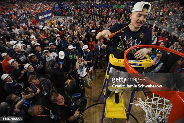 Kyle Guy of the Virginia Cavaliers cuts down the net after defeating the Texas Tech Red Raiders during the 2019 NCAA Photos via Getty Images Men's...