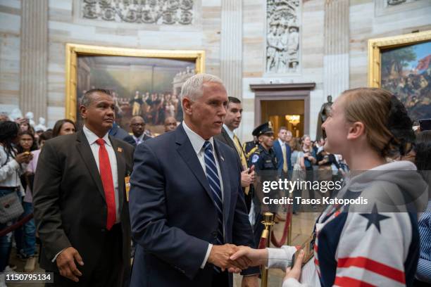 Vice President Mike Pence stops to greet and talk with tourists in the U.S. Capitol Rotunda after the weekly policy luncheons on May 21, 2019 in...