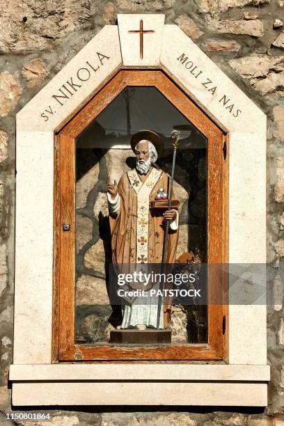 st. nicholas shrine built in wall of a stone house - saint nicholas stock pictures, royalty-free photos & images