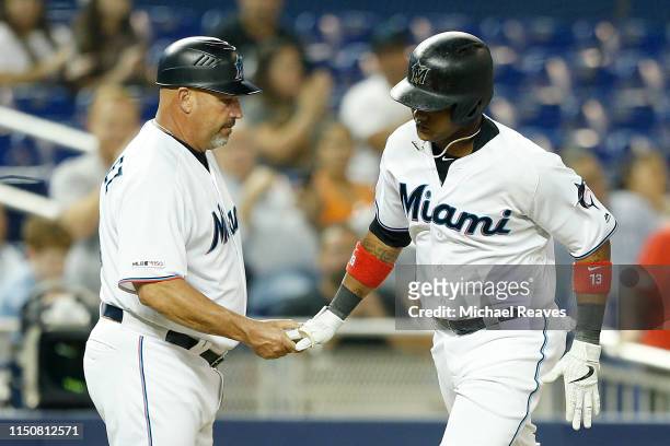 Starlin Castro of the Miami Marlins celebrates with third base coach Fredi Gonzalez after hitting a solo home run in the fifth inning against the New...