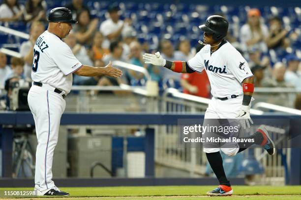 Starlin Castro of the Miami Marlins celebrates with third base coach Fredi Gonzalez after hitting a solo home run in the fifth inning against the New...