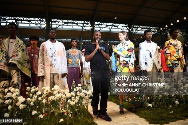American designer Virgil Abloh acknowledges the audience at the end of Off-White during the men's Spring/Summer 2020 collection fashion show on June...