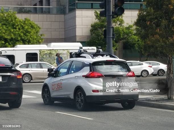 Driverless transport self-driving automobile from General Motor's Cruise division drives through traffic in the Mission Bay neighborhood of San...