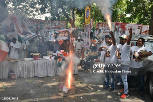 Congress party supporters burst crackers as they celebrate Indian National Congress President Rahul Gandhi's 49th birthday, outside party...