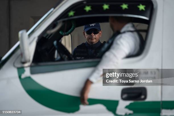 Member of the National Guard looks on at a checkpoint in Tuxtla Chico on June 19, 2019 in Chiapas state, Mexico. The Mexican government launched a...