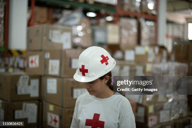 Red Cross volunteer works in a warehouse of International Committee of the Red Cross on June 19, 2019 in Caracas, Venezuela. A second shipment...