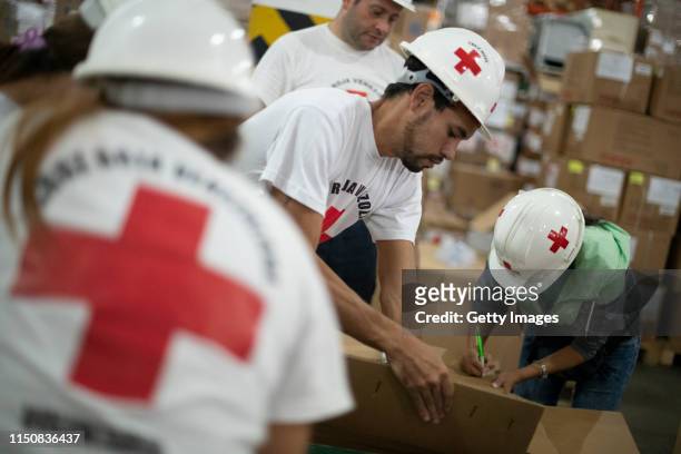 Volunteers repack medicines in a warehouse of International Committee of the Red Cross on June 19, 2019 in Caracas, Venezuela. A second shipment...