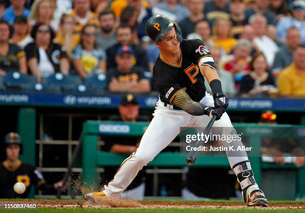Kevin Newman of the Pittsburgh Pirates check swings against the Detroit Tigers during inter-league play at PNC Park on June 19, 2019 in Pittsburgh,...