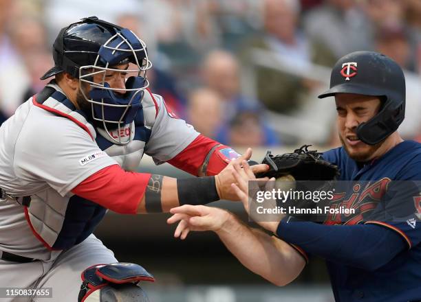 Sandy Leon of the Boston Red Sox defends home plate against C.J. Cron of the Minnesota Twins during the first inning of the game on June 19, 2019 at...