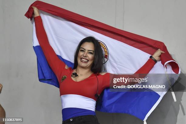 Paraguay's model Larissa Riquelme poses with her national flag during the Copa America football tournament group match between Argentina and Paraguay...