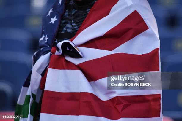 Mexico fan wears a flag draped around their sholders as they watch the CONCACAF Gold Cup Group A match between Cuba and Martinique, ahead of the...