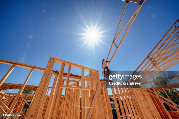 drone view of a home being framed by carpenters - residential building construction stock pictures, royalty-free photos & images