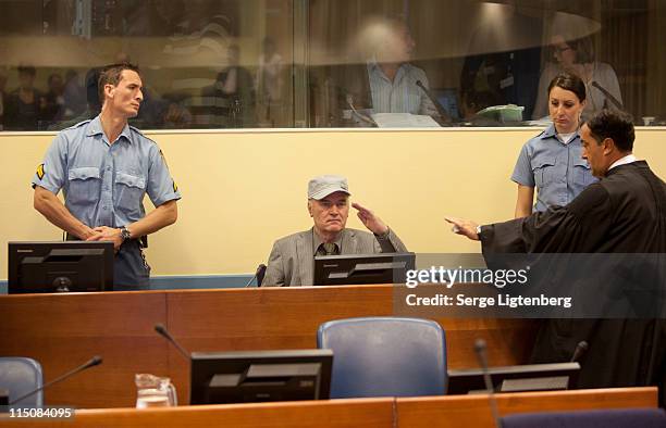 Former Bosnian Serb Military Leader Ratko Mladic salutes as he takes his seat in the International Criminal Tribunal where he faces war crime charges...