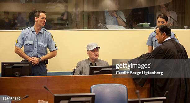 Former Bosnian Serb Military Leader Ratko Mladic takes his seat in the International Criminal Tribunal where he faces war crime charges on June 3,...