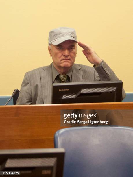 Former Bosnian Serb Military Leader Ratko Mladic salutes as he takes his seat in the International Criminal Tribunal where he faces war crime charges...