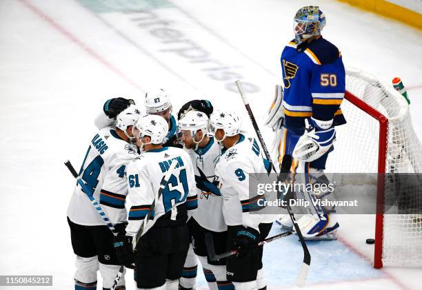 Dylan Gambrell of the San Jose Sharks celebrates with teammates after scoring a goal on Jordan Binnington of the St. Louis Blues during the second...