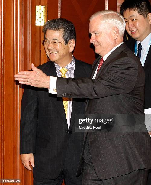 Secretary of Defense Robert Gates greets Japan's Defence Minister Toshimi Kitazawa before their bilateral meeting at the 10th International Institute...