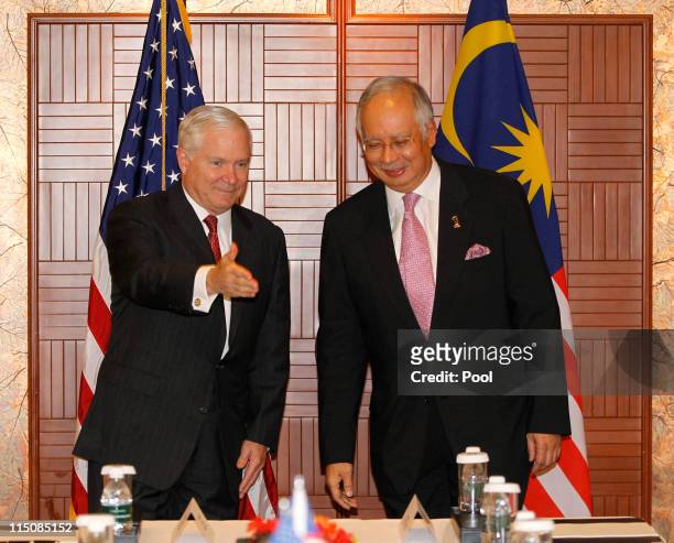 Secretary of Defense Robert Gates gestures as he meets with Malaysia's Prime Minister Mohamed Najib at the 10th International Institute for Strategic...