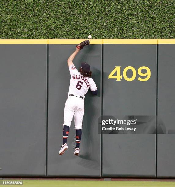 Jake Marisnick of the Houston Astros leaps at the wall but is unable to catch a ball off the bat of Jose Abreu of the Chicago White Sox that cleared...