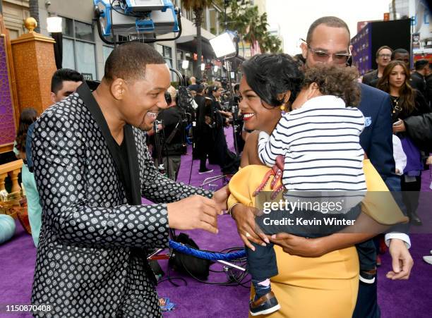 Will Smith, Tatyana Ali, Edward Aszard Rasberry and Vaughn Rasberry arrive at the premiere of Disney's "Aladdin" at the El Capitan Theater on May 21,...