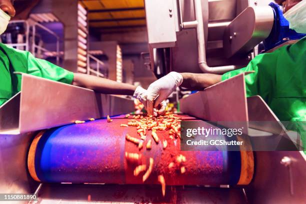 factory workers checking final production quality at a food processing plant - food additive stock pictures, royalty-free photos & images