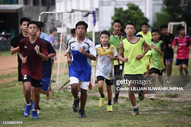 This photo taken on June 14, 2019 shows Wild Boars footballer Ekarat Bew Wongsukchan running with teammates at Ekkapol Coach Ek Chantawongs newfound...