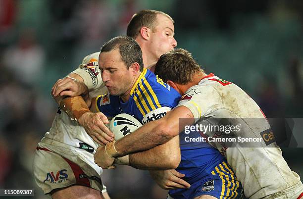 Luke Burt of the Eels is tackled during the round 13 NRL match between the Parramatta Eels and the St George Illawarra Dragons at Parramatta Stadium...