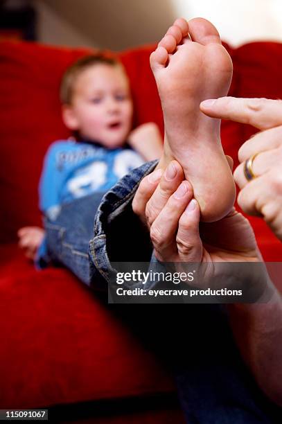 adult and adolescent portraits - tickling feet stock pictures, royalty-free photos & images