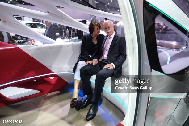 Dieter Zetsche, Chairman of Daimler AG, and his wife Anne sit in a Daimler Vision Urbanetic van at the annual Daimler AG shareholders meeting on May...