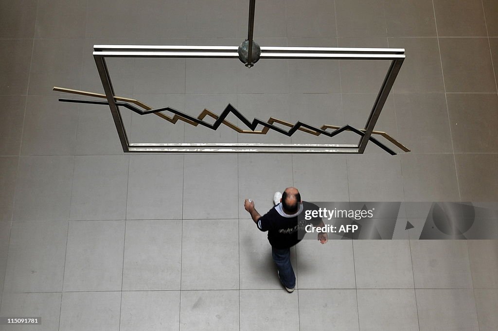 A man  walks by an index sculpture in th