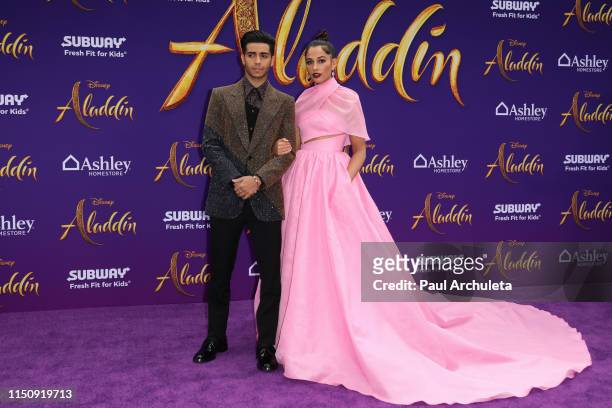 Actors Mena Massoud and Naomi Scott attend the premiere of Disney's "Aladdin" on May 21, 2019 in Los Angeles, California.