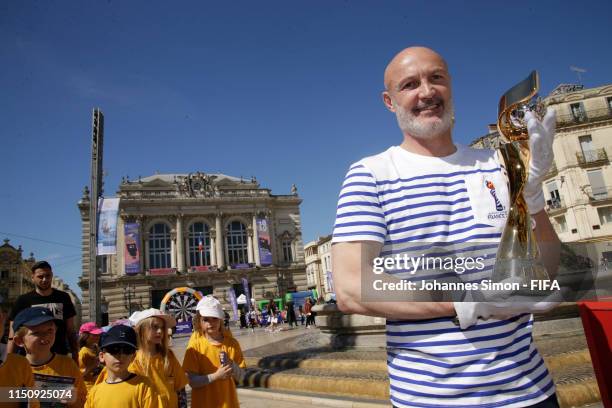 Legend Frank Leboeuf poses with the FIFA Women's World Cup trophy at Place de la Comedie during the FIFA Women's World Cup France 2019 National...