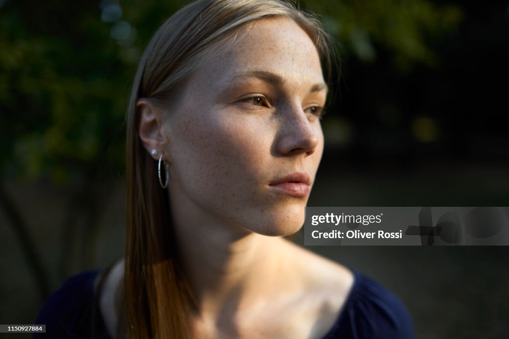 Portrait of young woman in sunlight