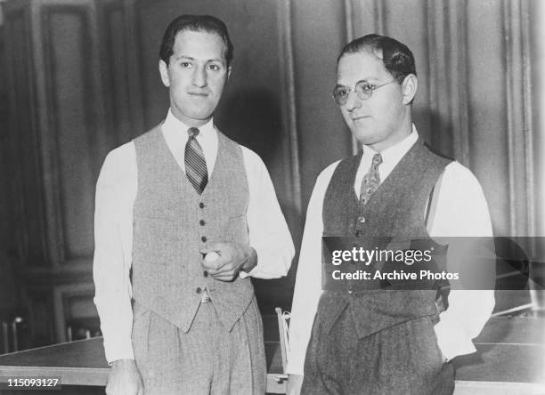 Brothers George and Ira Gershwin take a break from playing table tennis, circa 1925.