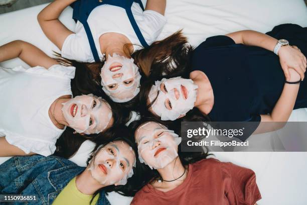 facial masks night with friends at home - cloth mask stock pictures, royalty-free photos & images