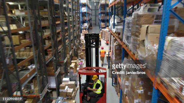 warehouse logistic center. worker driving on a forklift. aerial view - busy warehouse stock pictures, royalty-free photos & images
