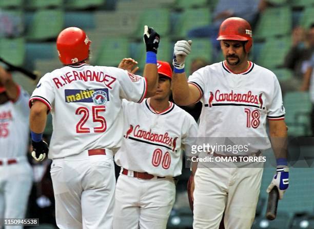 Ramon Hernandez , catcher of the Cardenales de Lara of Venezuela, is saluted by first baseman Luis Raven after hitting a homerun 07 Febraury 2001 in...