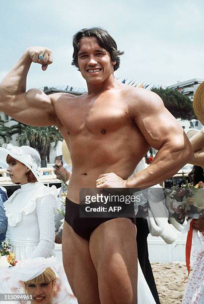 Picture taken 19 May 1977 of shows American actor Arnold Schwarzenegger posing during the 38th Cannes film festival, where he presented Pumping Iron,...
