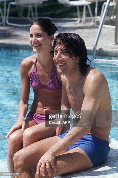 Actor Dustin Hoffman poses with his wife Anne Byrne, in his swimming pool Hotel, 14 May 1975, during the Cannes International Film Festival. In 1967...