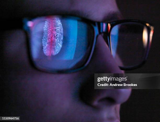 cyber security, reflection in spectacles  of access information being scanned on computer screen, close up of face - fingerprint scanner stock pictures, royalty-free photos & images