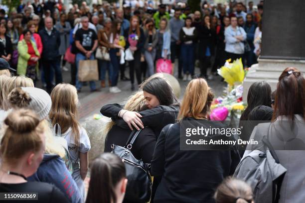 Two women hug during a two minute silence is observed in memory of the victims of the Manchester Bombing in Saint Anne's Square on May 22, 2019 in...