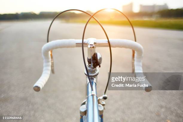 racing bike on rural road, personal perspective view of handlebars - handlebar stock pictures, royalty-free photos & images