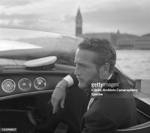 American actor Paul Newman, wearing a tuxedo and a bow tie, portrayed during a trip on a water taxi, a sailor cap on the dashboard, St. Mark Square...