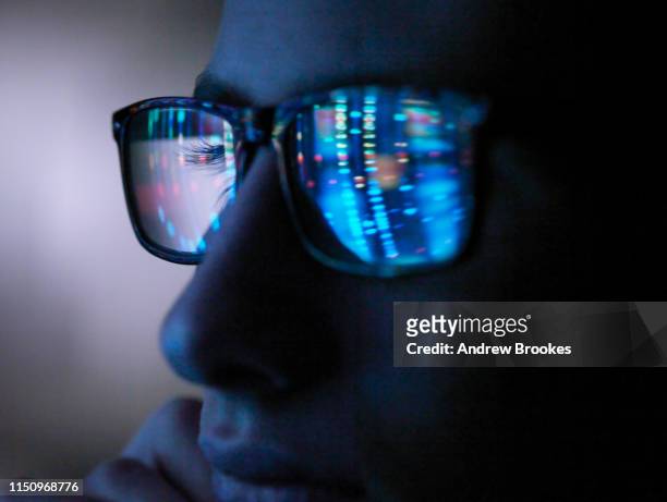 genetic research, computer screen reflection in spectacles of dna profile, close up of face - reflection photos et images de collection