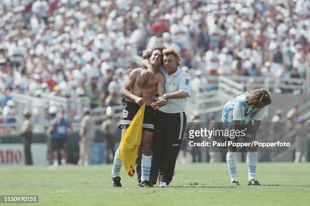 Argentine professional footballer Gabriel Batistuta, striker with Fiorentina, is consoled by a member of the Argentina coaching squad after Argentina...
